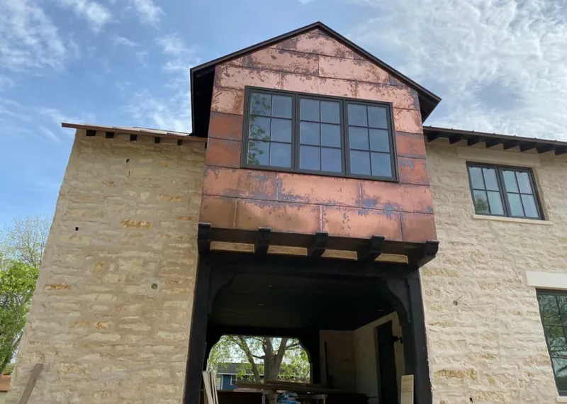 Copper metal panel facade on a stone building for Skylight Installation in South Bay